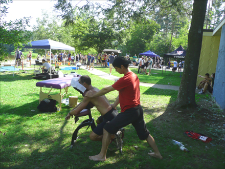 Alexandre Pazmandy is giving a chair massage at the Check for Change Triathlon in Chicopee, in August 2012